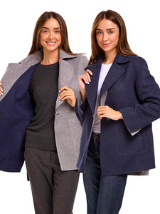 Two women wearing a reversible alpaca jacket on a white background