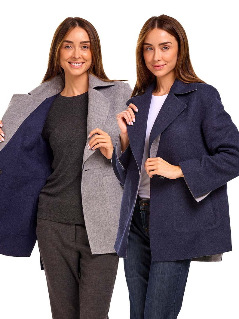 Two women wearing a reversible alpaca jacket on a white background